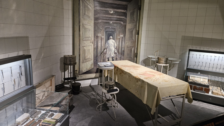 Museum display of bloody operating table with WWII surgical instruments