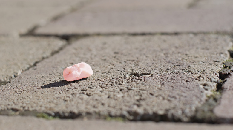 Spent piece of pink gum on sidewalk