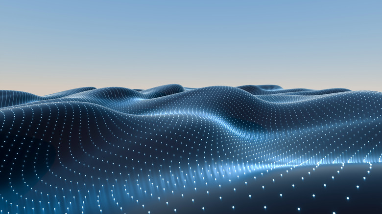 A 3D model of a field of waves dotted with white particles representing the quantum field