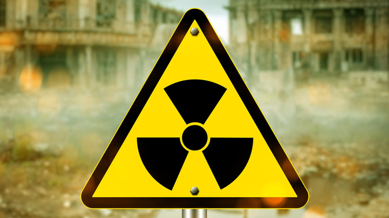 Radiation hazard warning sign in front of an abandoned building