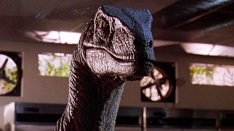 A velociraptor stands in a kitchen in Jurassic Park