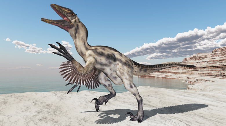 A 3D illustration shows a Deinonychus in a coastal landscape