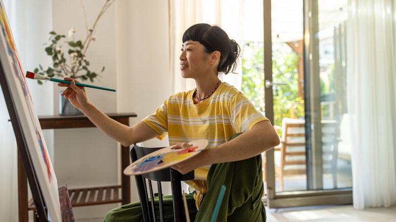 Woman painting on a canvas
