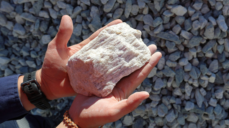 Person holding large piece of lithium ore