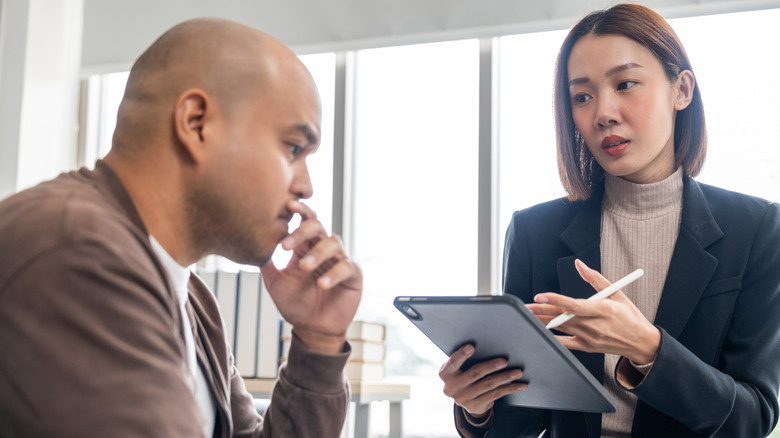 Man talking with a mental health professional while taking notes