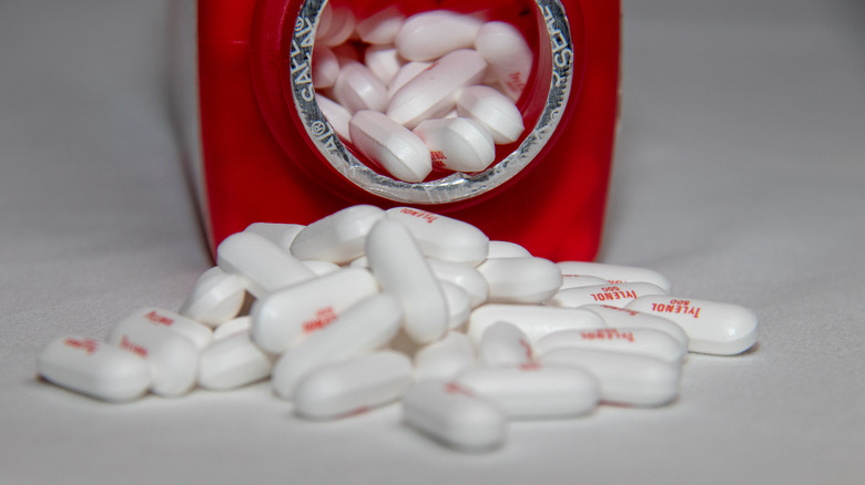 Tylenol spilling out of a bottle