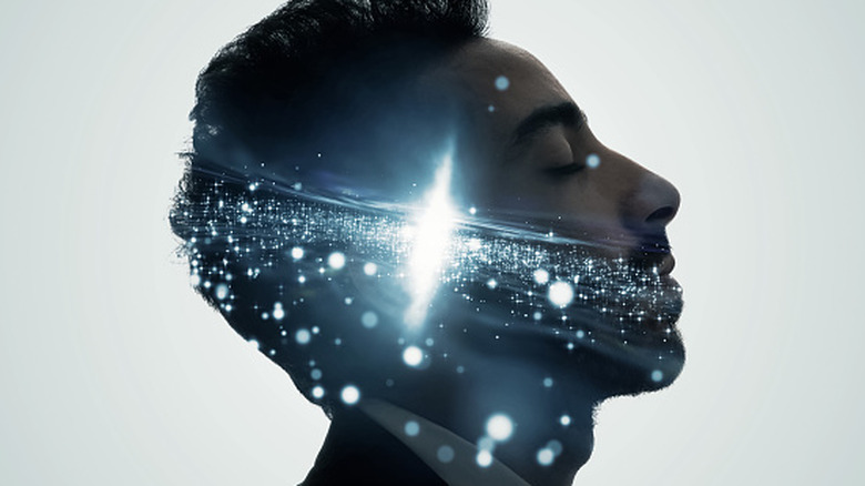 A man's head is seen in profile with light shining inside it