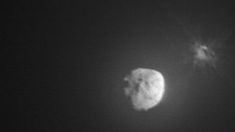 Image of Dimorphos and Didymos showing cloud of debris shortly after DART impact