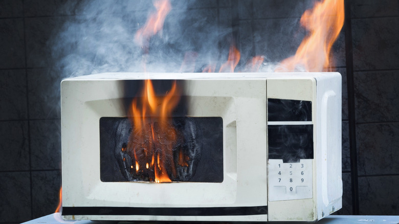 White microwave on fire