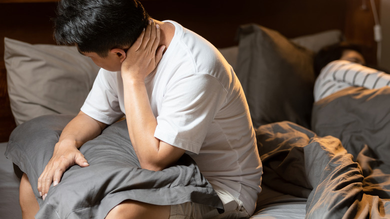 Man waking up from a bad night of sleep