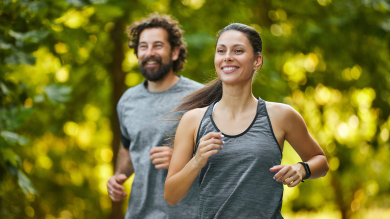 Young couple jogging in the woods