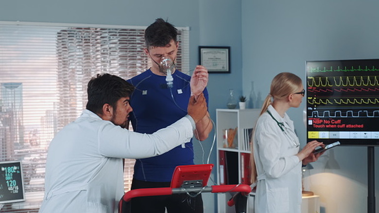 Medical professionals preparing person for a cardiopulmonary exercise test
