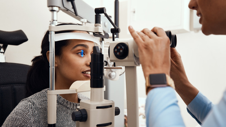 A woman receiving an eye exam