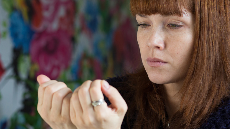 Woman inspecting her fingernails