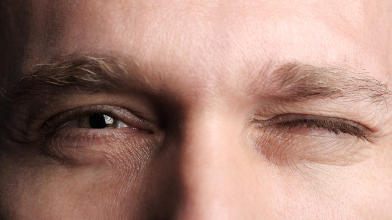 Closeup of man closing one eye