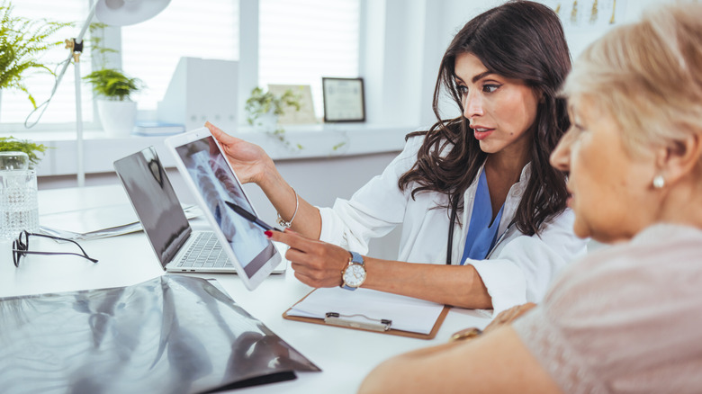 Doctor showing chest x-ray images to a patient