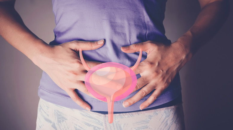 Person holding their lower abdomen, with image of bladder in front