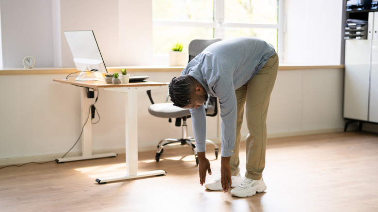 Person doing office stretches to combat sedentary lifestyle