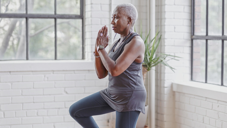 Senior woman balancing on one leg