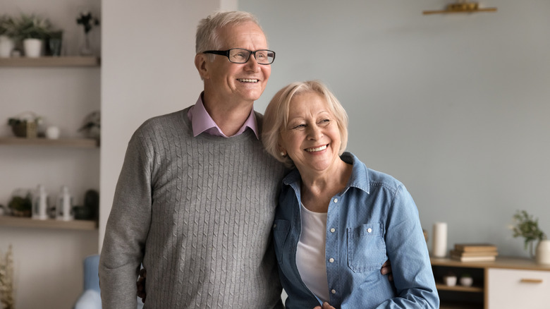 Senior couple in their home looking happy