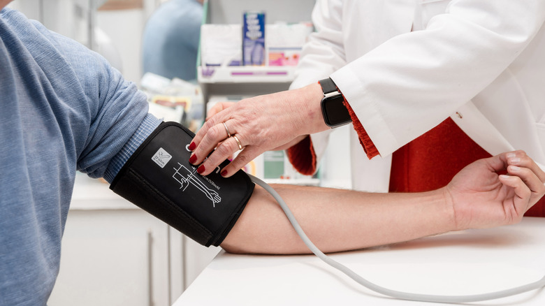 A healthcare provider taking a patient's blood pressure.