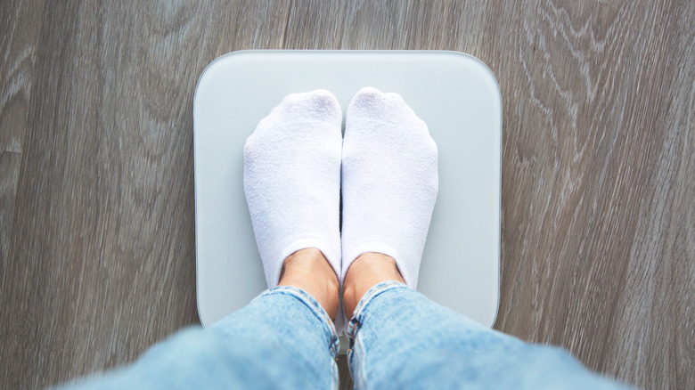 A close-up of someone standing on a scale.