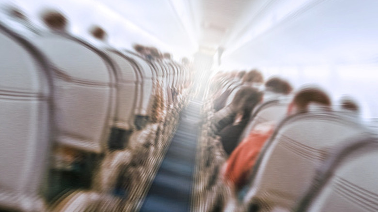 airplane passengers with motion blur from turbulence