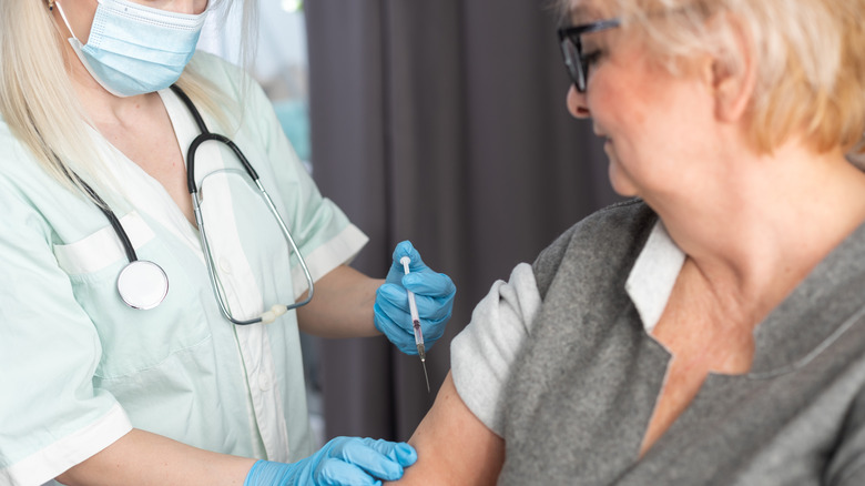 Woman receiving a vaccine in arm