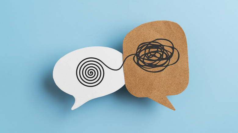 Speech bubbles with lines drawn in marker sit against a blue background