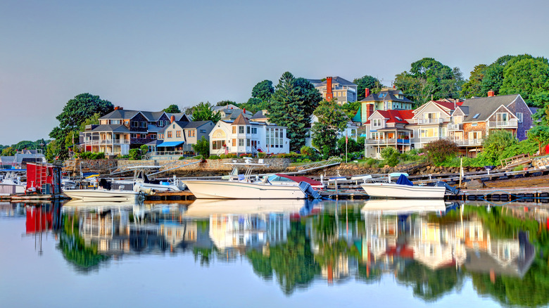 Gloucester MA, bayside houses, green trees and boats in the water