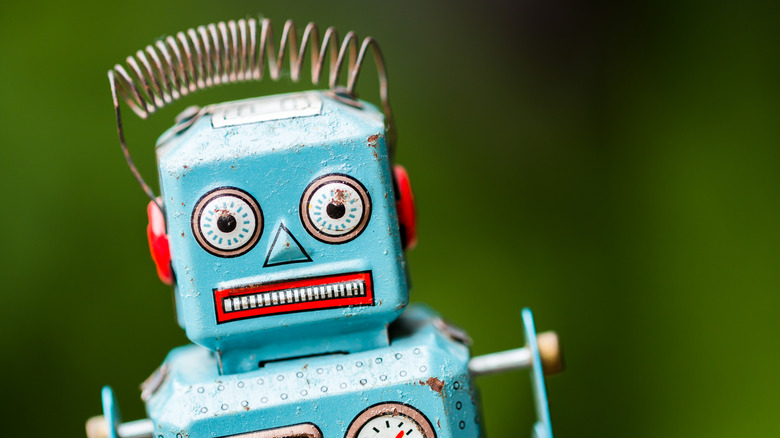 Retro robot toy with cringing expression