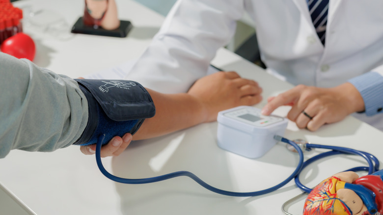 A doctor taking a patient's blood pressure