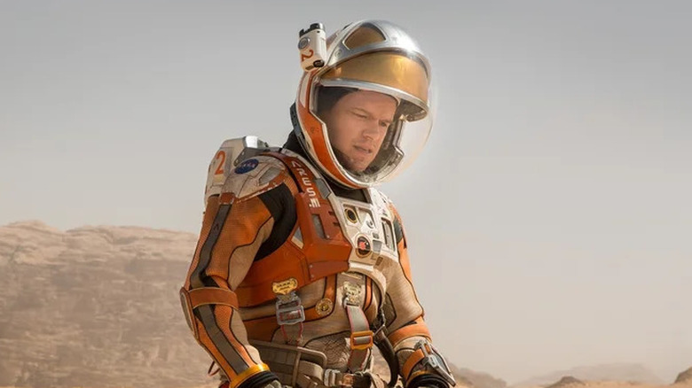 Matt Damon's Mark Watney kneeling in his EVA suit in The Martian