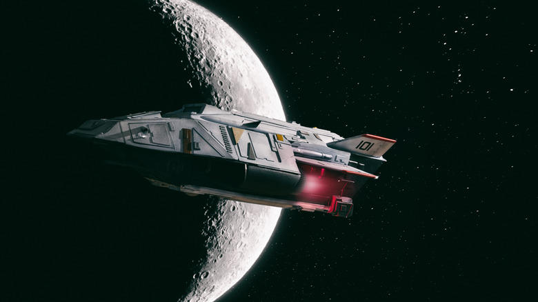 Spaceship flying in front of moon