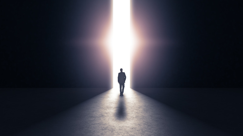 A rendering of a man walking toward a bright light