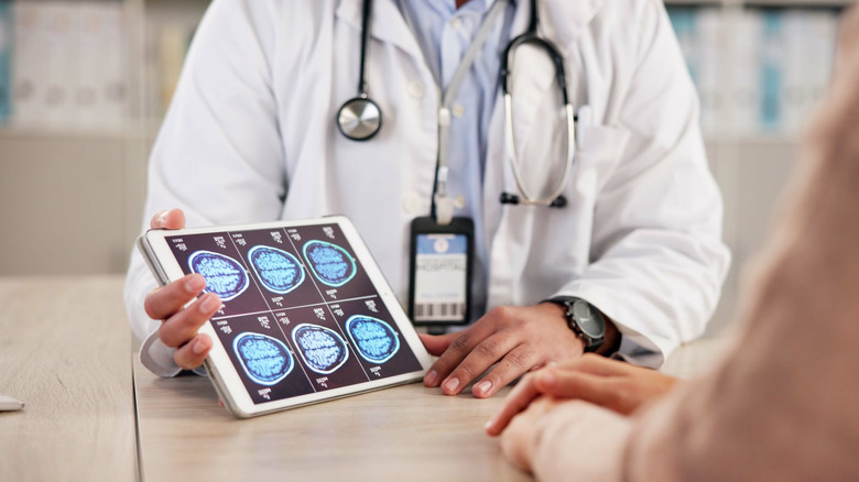 Doctor showing patient MRI images of brain