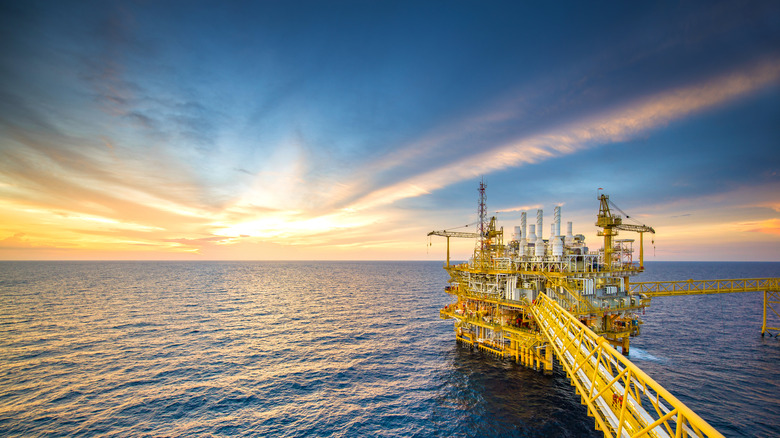 A large oil rig in deep ocean waters with no land visible