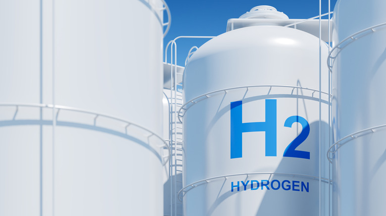 Hydrogen gas silos, white and large against clear sky