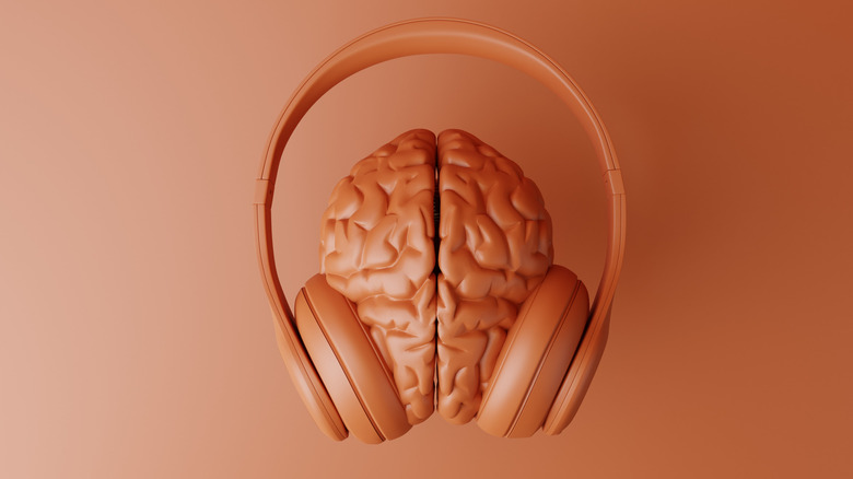 A model of headphones resting on a brain.