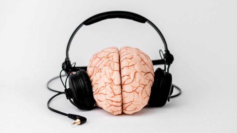 A fake human brain wearing headphones