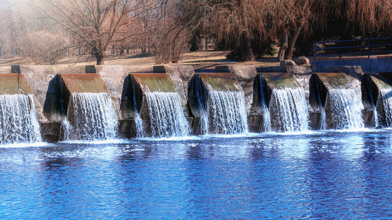 Water flows over a dam