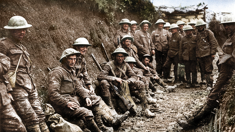 WWI German troops posing in trenches, some smiling, some grim-faced