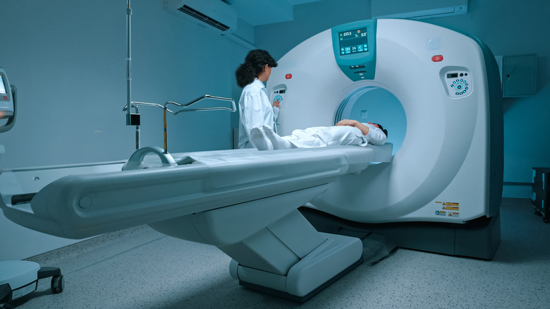 Patient in white going into an MRI machine