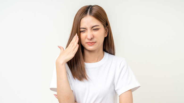 Young woman reacting to bad smell