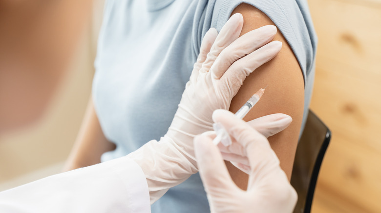 A healthcare professional administering a vaccine.