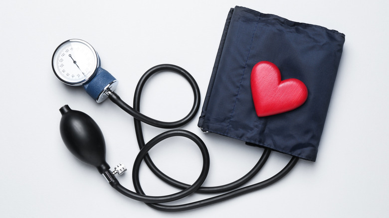 Plastic red heart on the cuff of a sphygmomanometer