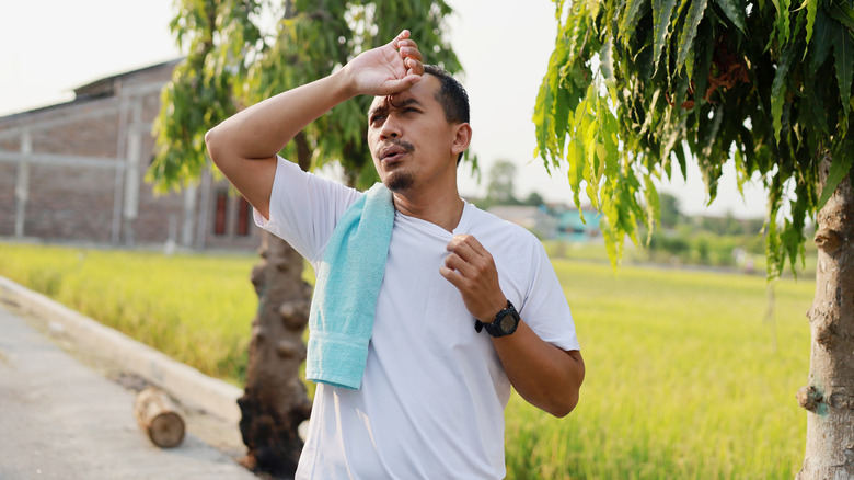 Man dealing with heat while exercising outdoors
