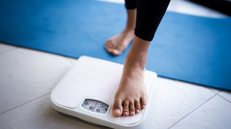 Feet stepping on a scale