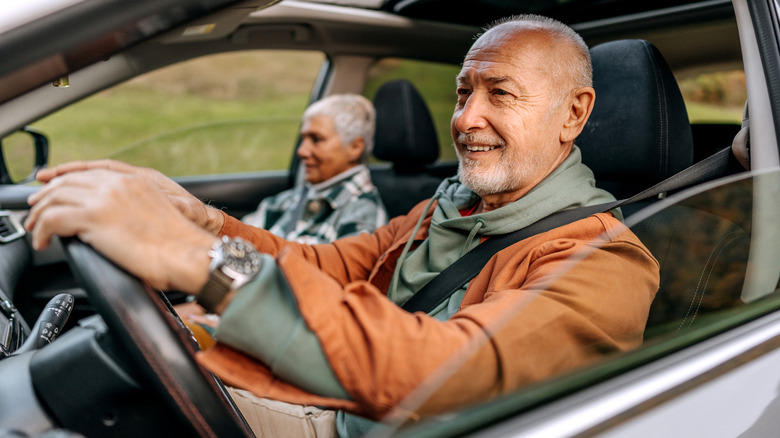 Man smiling while driving the car