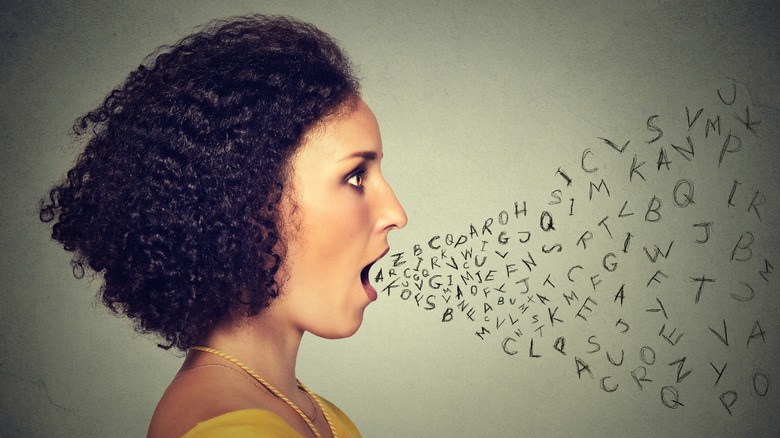 Young woman profile with mouth open and stream of scribbled letters leaving it